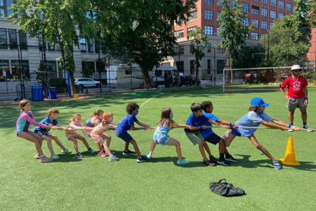 Children playing tug of war at the Youth Community Center Summer STEAM Camp